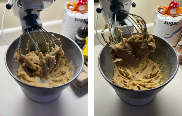 A KitchenAid mixer stands with cookie batter in the mixing bowl.