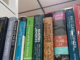 A close-up of the spines of several books of various colors standing up in a row.