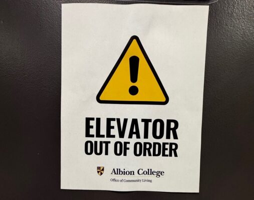 A sign posted on an elevator door that reads “ELEVATOR OUT OF ORDER.”