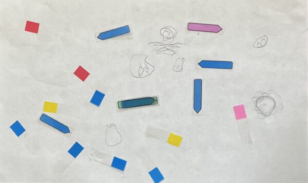  A pencil drawing of various shapes and figures. On the paper is a variety of pink, blue, red and yellow sticky notes.