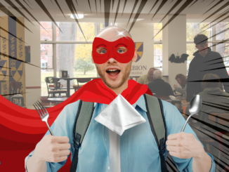 A young man in a red cape and eye mask holds up a fork and spoon, a napkin tucked into his collar. Behind him is a large, open restaurant space with dark zoom lines around the figure in the middle.
